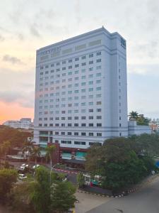 a large white building with a sign on it at Four Points by Sheraton Batam in Nagoya