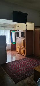 a room with wooden doors and a red rug at Die Blom in Krugersdorp