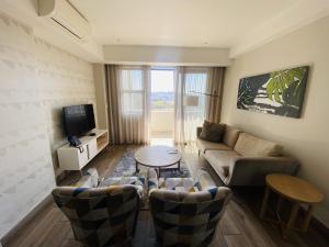 a living room with a couch and a table at Stay Regency Menlyn in Pretoria