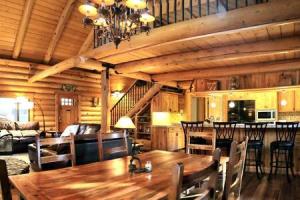 a wooden dining room with a wooden table and chairs at Eagles Nest - Natural Log Cabin with Guest House in Idyllwild