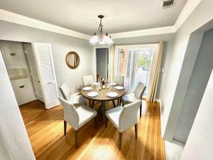a dining room with a table and chairs at Entire 5BR Home Hot Tub-Firepit-Patio-Grill in San Diego