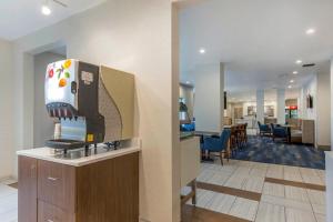 a hotel lobby with a coffee maker on a counter at Holiday Inn Express and Suites Chicago West - St Charles, an IHG Hotel in Saint Charles