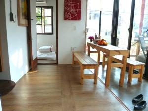 a dining room with a table and a bench at Guesthouse in Picture in Jeonju