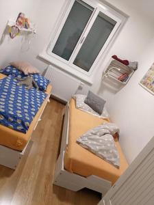 Zimmer mit 2 Betten und einem Fenster in der Unterkunft Wundervolle Familienwohnung nahe Schönbrunn in Wien