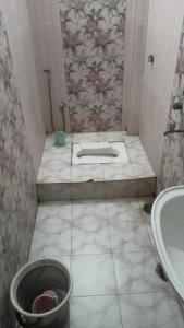 a bathroom with a tub and a sink and a bucket at OYO Hotel Krishna Internation in Muzaffarpur