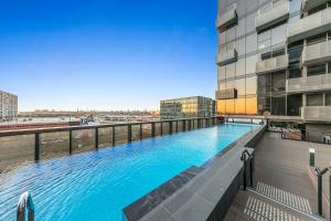 a swimming pool on the roof of a building at Sol Docklands - Unique 3 Bedroom Loft, Infinity Pool, Gym, Free Parking and Free Trams in Melbourne