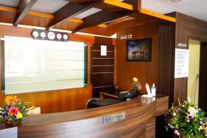 an office with a reception desk with flowers on it at HOTEL MEENAKSHI in Kolattupuzha