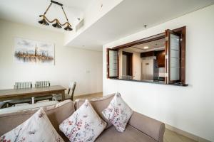 a living room with a couch and a table at ALH Vacay - 2 bedrooms Apartment in Golf Towers 1 in Dubai