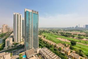 an aerial view of a tall building in a city at ALH Vacay - 2 bedrooms Apartment in Golf Towers 1 in Dubai