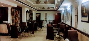 a dining room with chairs and tables in a room at HOTEL CONCLAVE EXECUTIVE in New Delhi