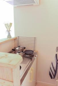 a kitchen with a stove with pots and pans on it at Bed met Paard in Bergen op Zoom