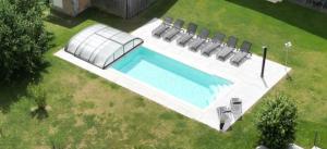 Draufsicht auf ein Schwimmbecken mit Stühlen in der Unterkunft Landurlaub Eichinger inklusive AktivCard! E-Ladesäule! Ganz Jahres beheizter Salzwasserpool in Thurmansbang + 23 Fotos