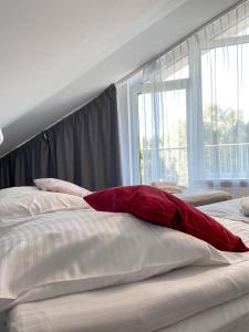 Ένα ή περισσότερα κρεβάτια σε δωμάτιο στο Ośrodek Magnolia