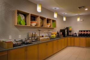 cocina con armarios de madera y encimera en SpringHill Suites St Petersburg Clearwater, en Clearwater