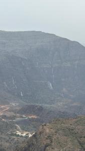 a view of a mountain with a town on it at بيوت الخزام in Salmah