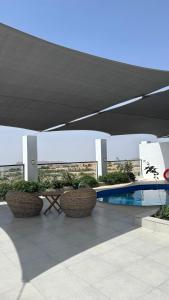 um pátio com uma mesa de piquenique e uma piscina em بيوت الخزام em Salmah