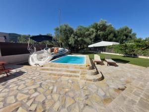 a boat is parked next to a swimming pool at Villa Morris in Nydri