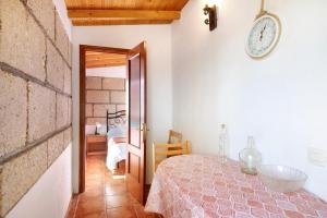 a bedroom with a bed and a clock on the wall at Verode in Arico +22 photos