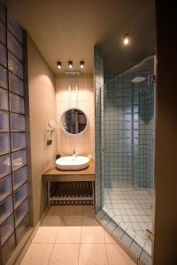 a bathroom with a sink and a shower at Sandali Metekhi Boutique Hotel in Tbilisi City