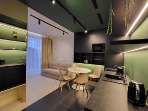 a kitchen and living room with a table and a couch at Apartament Bel Mare F 604 in Międzyzdroje