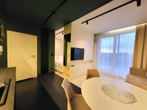 a room with a table and chairs and a bedroom at Apartament Bel Mare F 604 in Międzyzdroje