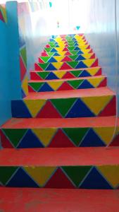 a colorful staircase in a room with a colorful floor at NeNeKaTo Nubian House in Aswan