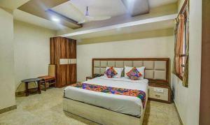 a bedroom with a large bed in a room at FabHotel Chennai Palace in Chennai
