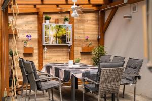 a patio with a table and chairs and a window at Chalet FERIENHAUS LADERDING mit Sauna in Bad Hofgastein