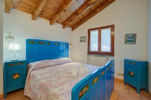 a bedroom with a blue bed and two blue cabinets at Villa Il Castagno Few Min From Beach - Happy Rentals in Castelveccana