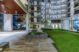 a large apartment building with a lawn in front of it at Vintage GreyRoom - Family Stay in Dhaka