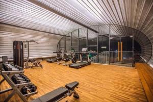 a gym with rows of exercise equipment in a room at Vintage GreyRoom - Family Stay in Dhaka