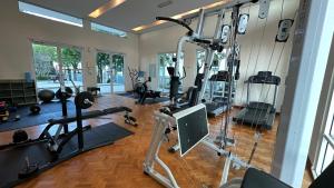 a gym with several treadmills and exercise equipment at Cozy Straits Quay Seafront Suite in Tanjong Tokong