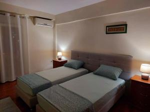 a hotel room with two beds and a couch at Solaris Guest House in Shkodër