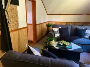 a living room with a blue couch and a table at Lodge Blue Mount Hakuba in Hakuba +33 photos