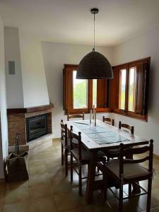 a dining room with a table and chairs and a chandelier at Can Catrol in Santa Cristina d'Aro