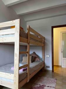 a bedroom with two bunk beds in a room at Can Catrol in Santa Cristina d'Aro