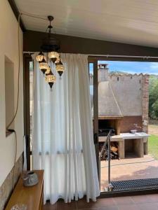 a room with a white curtain and a table at Can Catrol in Santa Cristina d'Aro