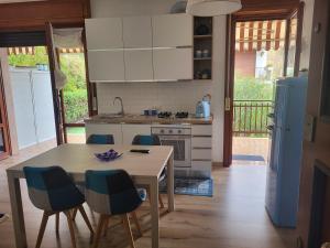 eine Küche mit einem Tisch, einem Tisch und Stühlen in der Unterkunft A casa di Clo' in Sanremo