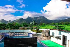 a resort with a view of the mountains at Wayfare SP Resort in Panvel