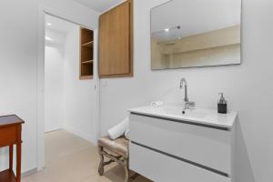a white bathroom with a sink and a mirror at Villa Nandina in Trans-en-Provence