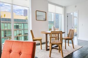 a dining room with a table and chairs and windows at Spectacular 3BDR & BTH in DTLA with pool, gym and balcony amazing views in Los Angeles