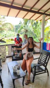 a woman sitting on a chair in a room at freedom house in Unawatuna