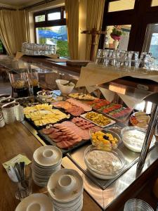 a buffet with many different types of food on a table at Hotel Haus am See in Bad Salzuflen