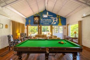a living room with a pool table in it at Citrus County, Hoshiarpur, amã Stays & Trails in Hoshiārpur