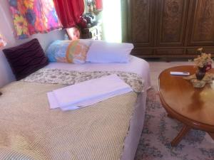 a bedroom with a bed and a wooden table at U Villi BB2 Gornji Zalik bb in Mostar