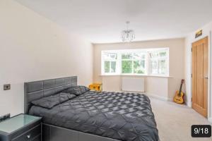 a bedroom with a bed and a window at The Fairways, St Bernard’s Road in Olton