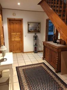 a living room with a staircase and a rug at Ferienhaus Gartower See in Gartow +35 photos