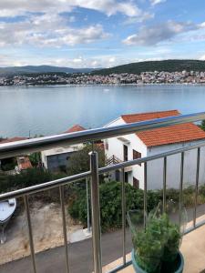 a balcony with a view of a body of water at AC apartment in Okrug Gornji