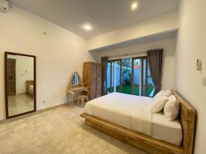 Giường trong phòng chung tại Uma Villa Canggu