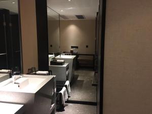a bathroom with three sinks and a mirror at Paco Hotel Dongpu Guanghzou -Free Shuttle Bus for Canton Fair in Guangzhou